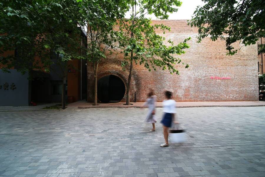 Spherical entrance embedded in the wall at Langyuan, Beijing, forming a spatial portal into the restaurant.