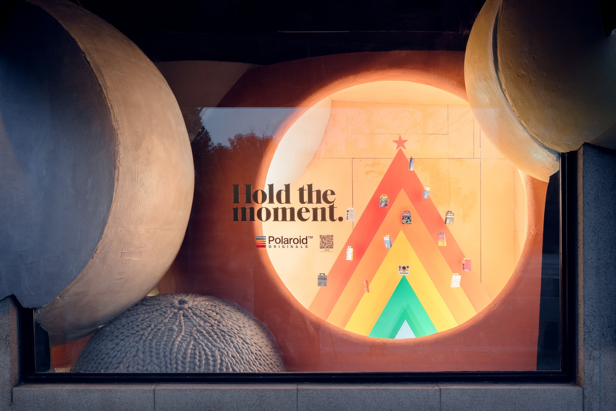 Right-side Polaroid Christmas window, where yarn balls and product display form an immersive holiday scene.