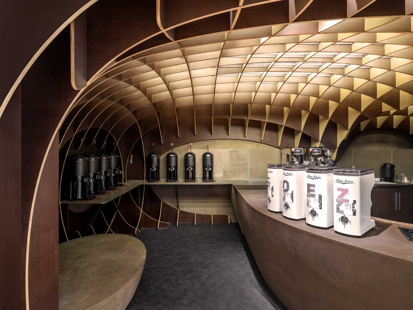 Interior view of the black coffee zone, where dark waffle structure encloses the counter and coffee display interface.