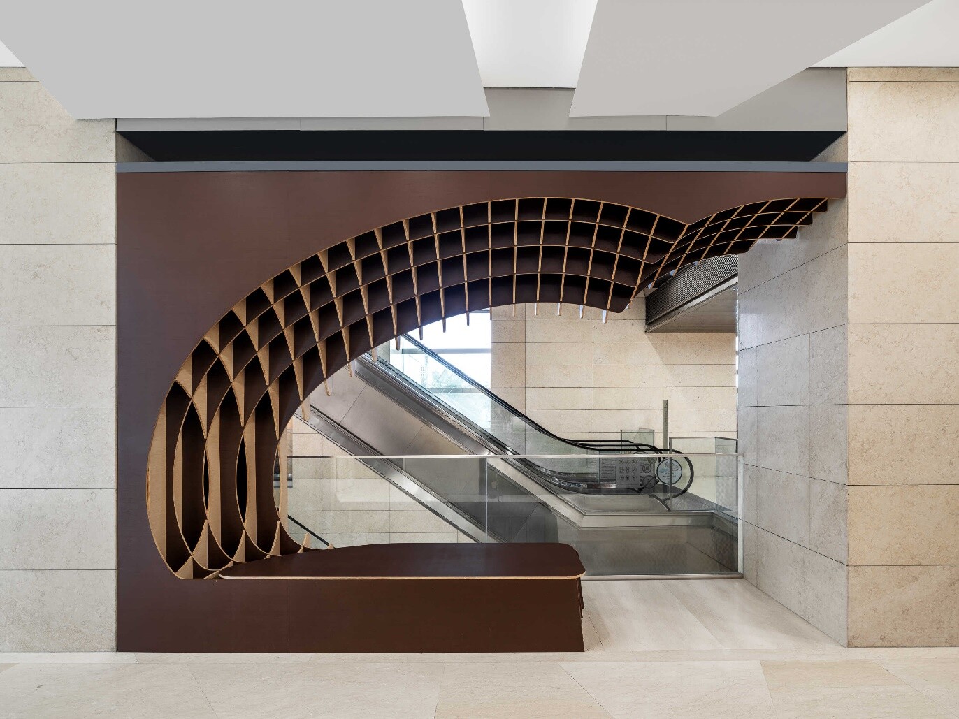 Waiting area across the corridor, where the coffee-bean curve continues to provide space for pausing and interaction.