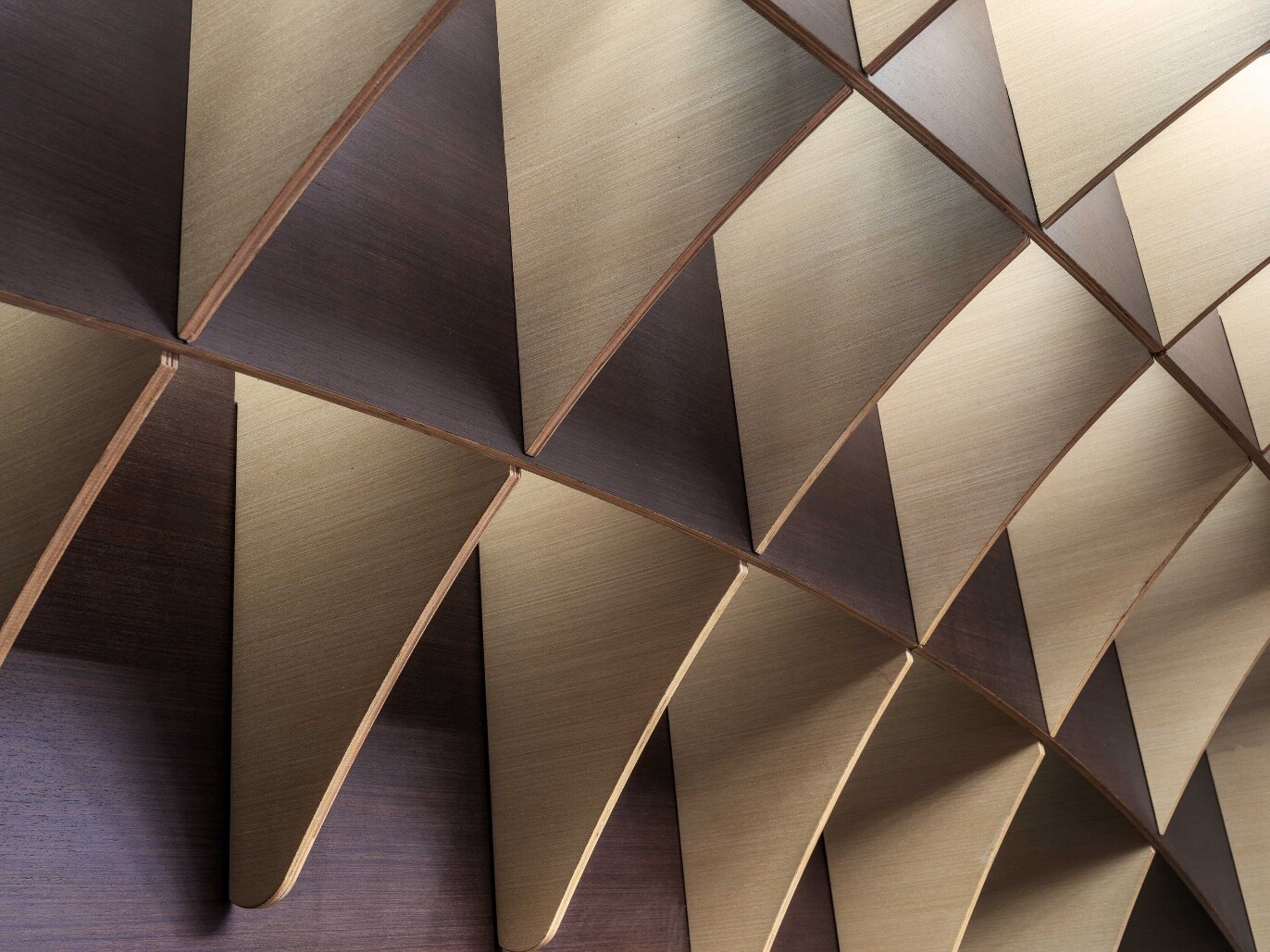 Detail at the junction of dark and light materials, expressing the double-sided black-and-white coffee theme.
