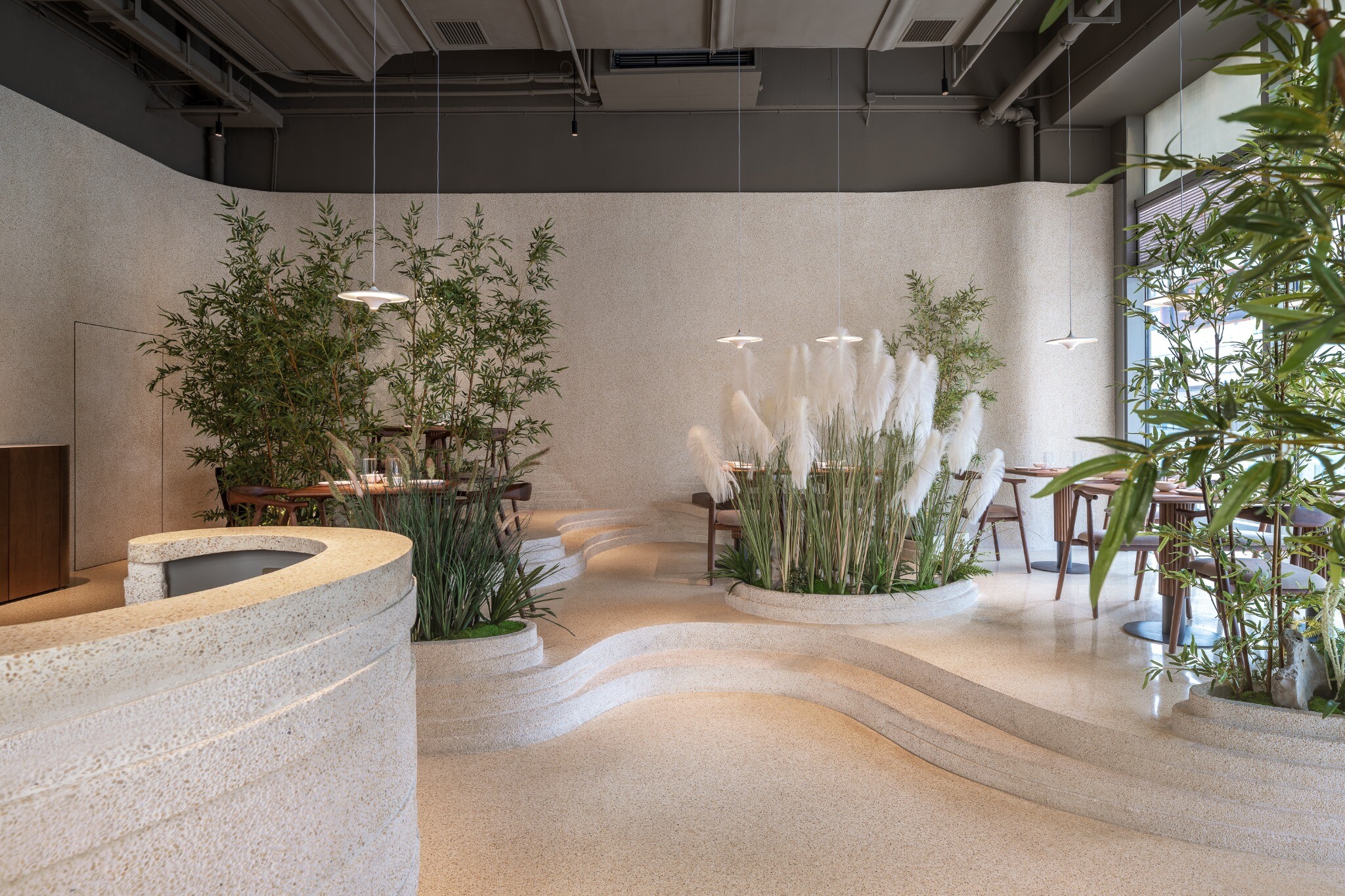 Winding path leading to the second-floor dining area, showing the space unfolding upward like a landscape painting.