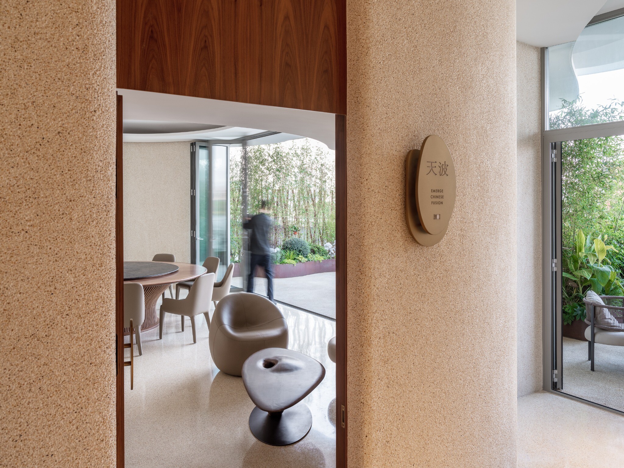 Curved corridor leading to the second-floor private rooms, showing natural curves and spatial guidance.